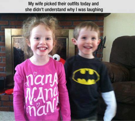 A girl and boy are standing side by side.  The girl is wearing a shirt that says, 